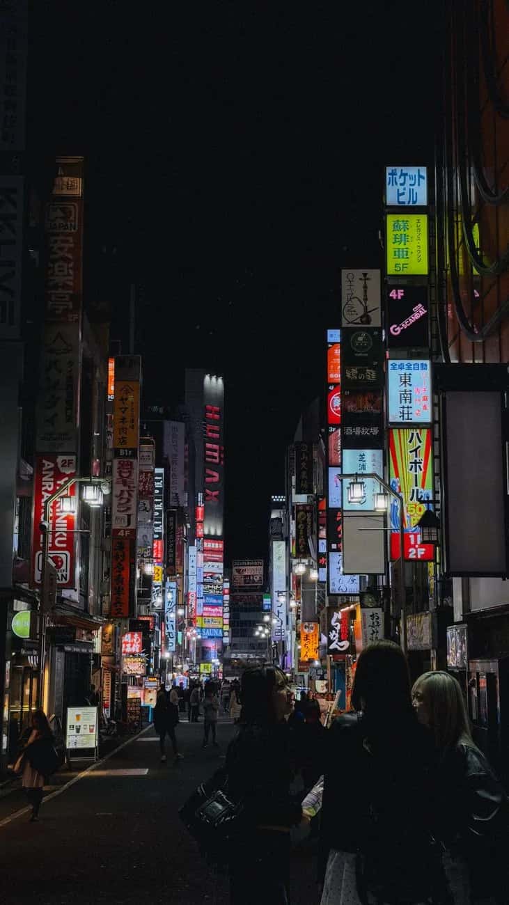 Ruelle de Kabukicho couverte d'enseignes lumineuses la nuit
