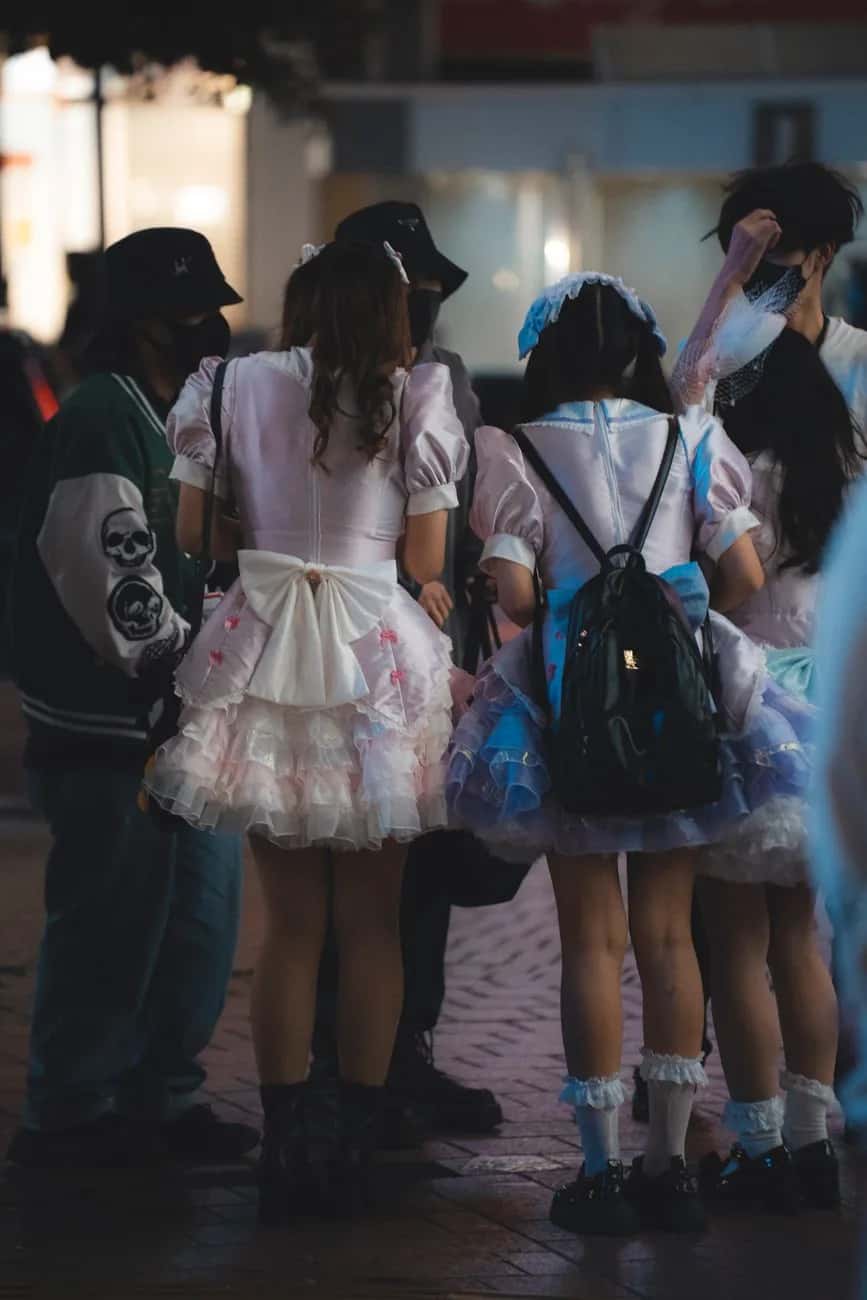 Jeunes femmes en robes lolita à jupons pastel, vues de dos dans une rue de Tokyo