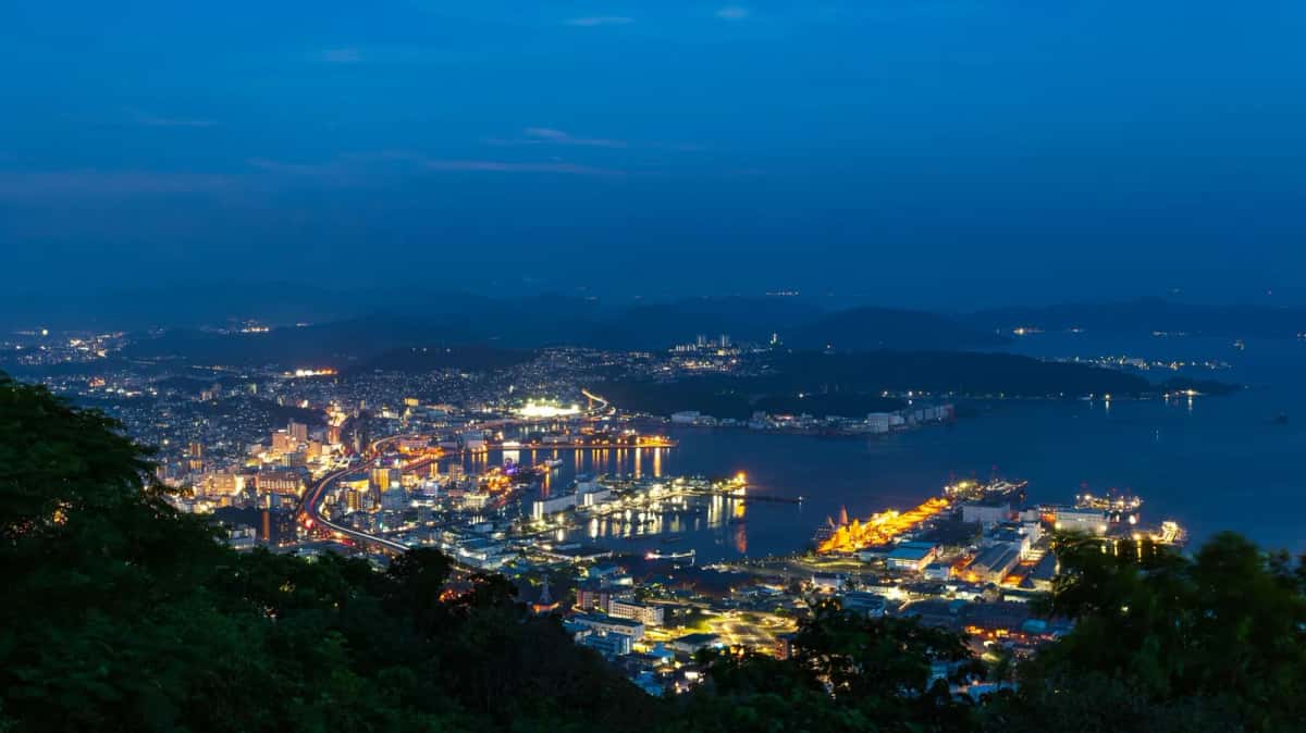 Vue nocturne depuis les hauteurs sur une baie illuminée de la préfecture de Nagasaki, Kyushu